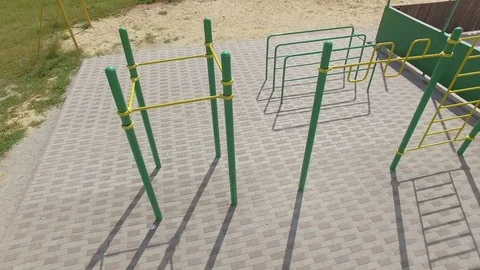 People train on an outdoor sports field in summer, aerial shot Stock Footage