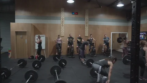 People training and getting coached in a crossfit gym Stock Footage 100435140