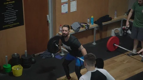 People training and getting coached in a crossfit gym Video stock 100436599