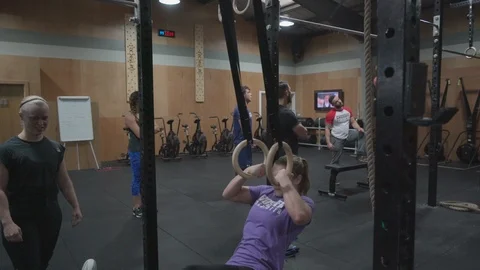 People training and getting coached in a crossfit gym Stock Footage 100438198