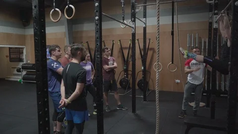 People training and getting coached in a crossfit gym Stock Footage 100441044