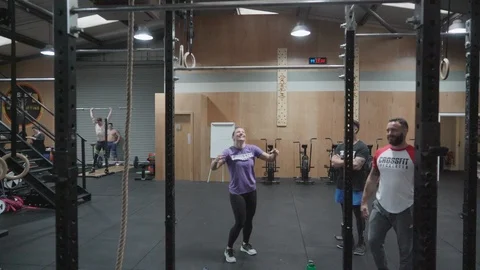 People training and getting coached in a crossfit gym Stock Footage 100442625