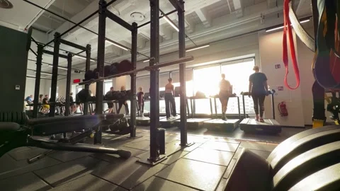 People training on treadmills in large modern gym hall Stock Footage 330135590