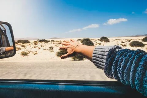 People traveling by car and summer holiday vacation concept - woman's hand pl Stock Photos