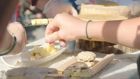 People trying different cheese samples at street market close up Stock Footage 267355491