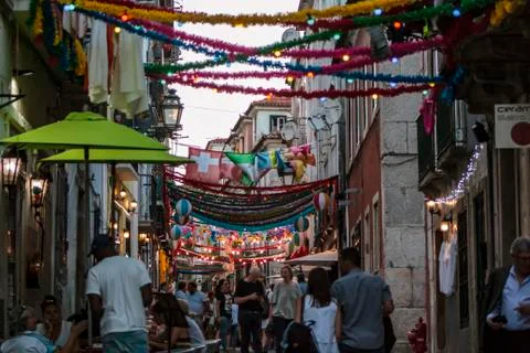 People in typical Lisbon neighborhood decorated for the popular saints Stock Photos