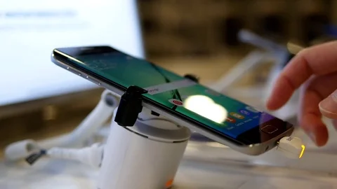 People typing message on Samsung Galaxy Note 7 cellphone at store Stock Footage 72137631
