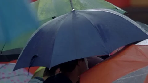 People with umbrellas under the rain Stock Footage 48675542