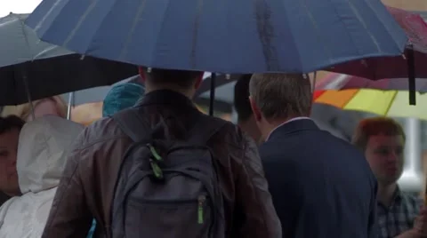People with umbrellas under the rain Stock Footage 48675557