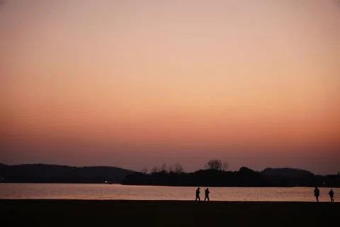 People under sunset, shadow Stock Photos