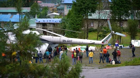 People Unloading Logistic From Big Helicopter at TenzingHillary Airport Stock Footage 94723476