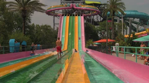 People (Unrecognizable) Racing Down Multi-colored Waterpark Slides Stock Footage 24674825