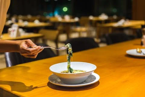 People use fork for pick Spinach cheese in the dish. Stock Photos