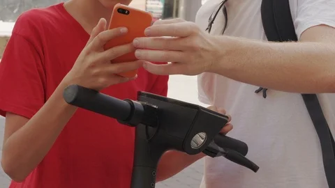 People use mobile app to unlock electric scooter, sharing Stock Footage 115210295