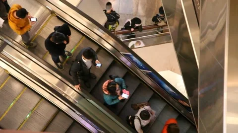 People use mobile cell phone the escalator in Langham Place mall Stock Footage 40729446