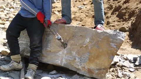 People using Chisel and Hammer to Break the Rock Stock Footage 145541846