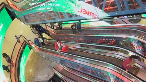 People using colorful escalator inside a shopiing Mall, Moscow, Russia Stock Footage 154841692