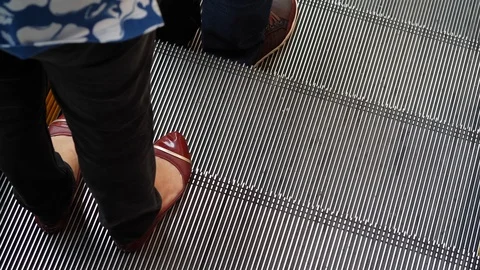 People using escalator moving down transport in floor of modern building Stock Footage 88329157