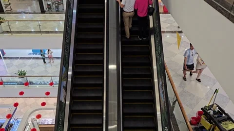 People using escalators inside a modern shopping mall in Vietnam. Stock Footage 319753044