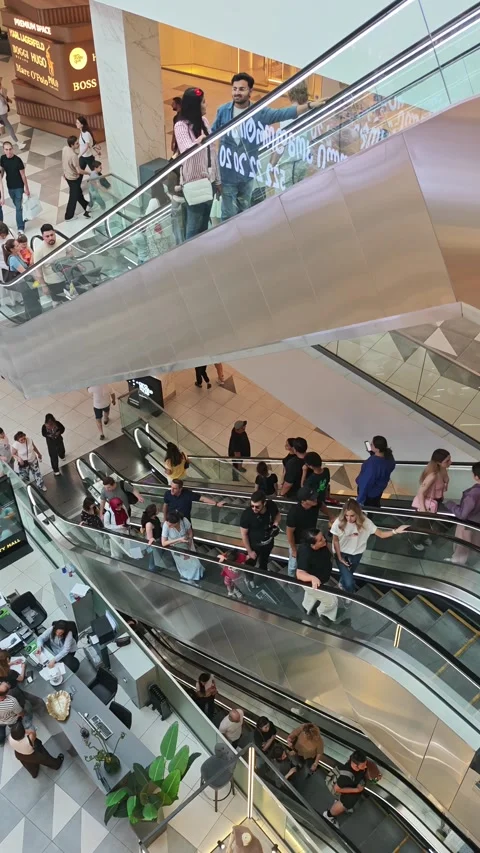 People using escalators in modern shopping mall Stock-Footage 315360066