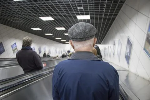 People using escalators in subway station. Stock photo. Stock Photos