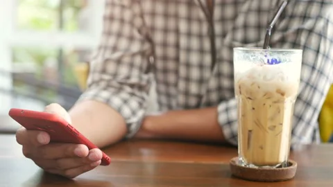 People using mobile smartphone at coffee shop, use finger touch on screen Stock Footage 132780571