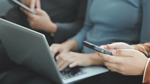 People using multiple devices sitting together for study and work Stock Footage 325351282
