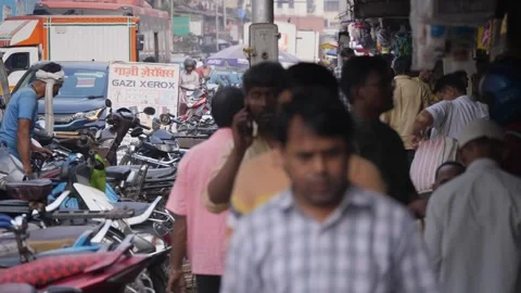 People using a narrow sidewalk with slow moving traffic on congested road Stock Footage 329098796
