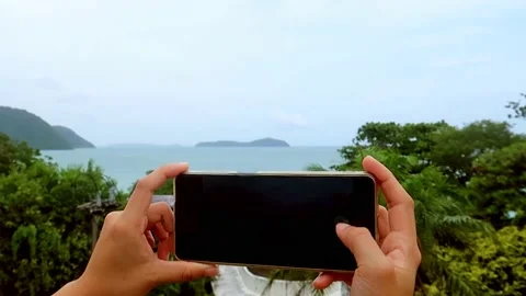 People using smart phone touchscreen to take picture or video of Ocean sea view Stock Footage 219017914