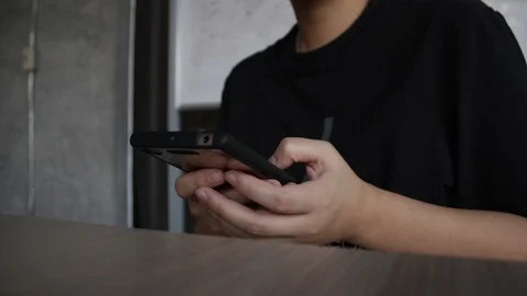 People using smartphone at coffee shop Stock Footage 105582430