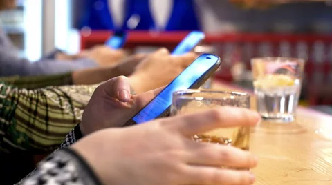 People using smartphone in a pub: social network, mobile phones, bar counter Stock Footage 49768480