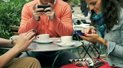 People using smartphone in the street cafe, steadycam shot Видео 43088643