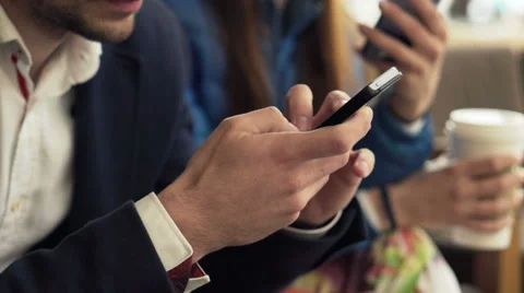 People using smartphone while sitting in cafe in city Stock Footage 52973917