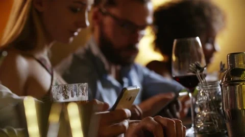 People using smartphone while sitting in luxury bar Stock Footage 67286655