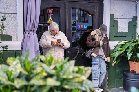 People using smartphones representing technology generation gap 스톡 사진