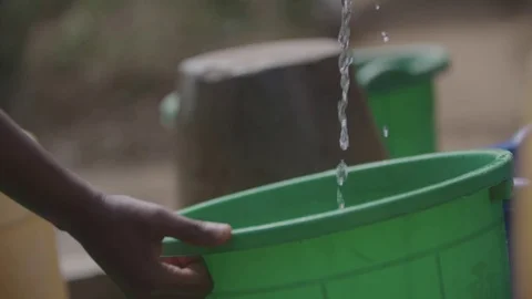 People using the water pump East Africa Malawi Stock Footage 74390968