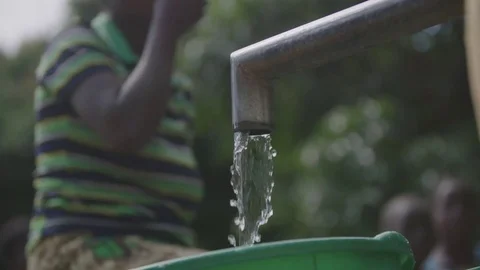 People using the water pump East Africa Malawi Stock Footage 74391072