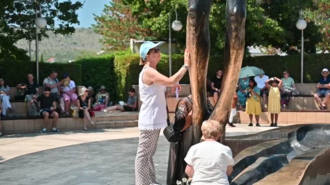 People venerating the statue of the Risen Christ in Medjugorje. Stock Footage 244603731
