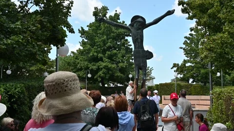 People venerating the statue of the Risen Christ in Medjugorje. Stock Footage 283594954
