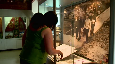 People Viewing Old Documents Inside Glass Case Stock Footage 56147109