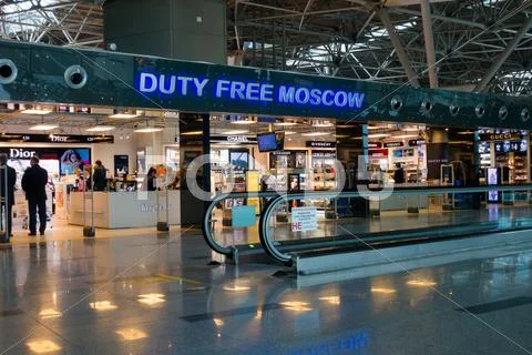 People visit duty free shop in Vnukovo airport at evening Stock Photos