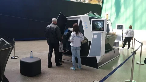 People visit an Interactive 3d cabin with space ship flight imitation Stock Footage 88549072
