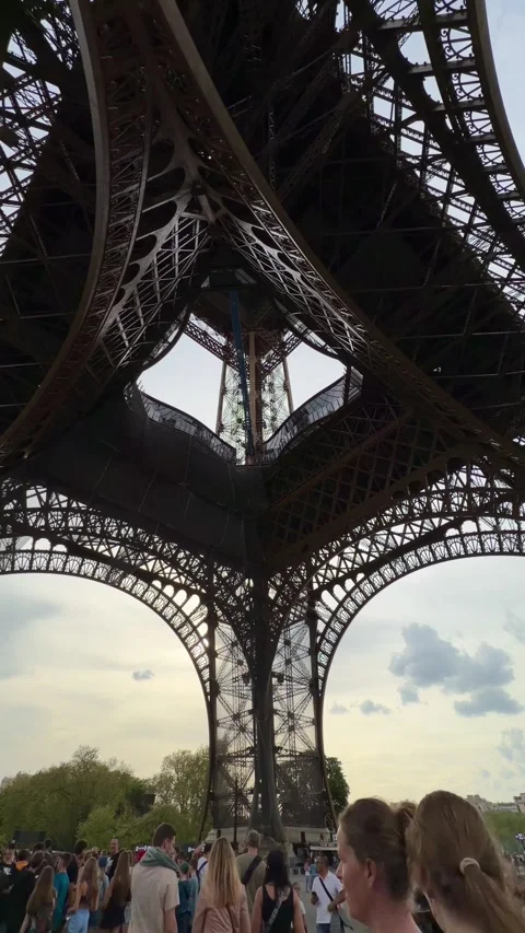 People visiting the Eiffel Tower in Paris, France during popular travel season Stock Footage 334119004