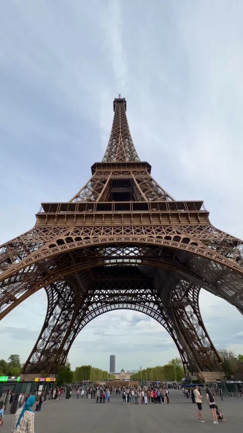 People visiting the Eiffel Tower in Paris, France during popular travel season Stock Footage 334119016