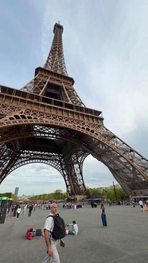 People visiting the Eiffel Tower in Paris, France during popular travel season Stock Footage 334119094