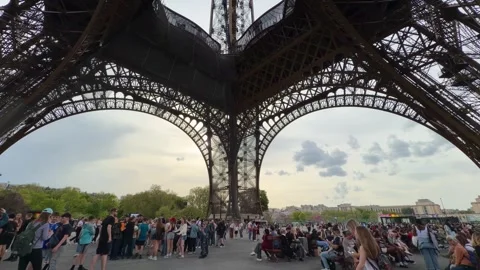 People visiting the Eiffel Tower in Paris, France during popular travel season Stock Footage 334119285