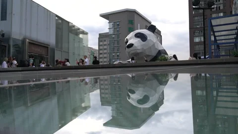 People visiting next to a large scale sculpture of panda in Chengdu Stock Footage 142446704