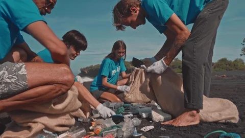 People Volunteers Sorting Garbage. Beach Tidying Up Rubbish, Charity and Ecology Stock Footage 125068679