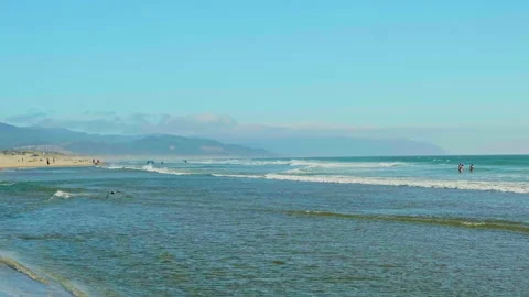 People wading in the ocean waves along the sandy beach of Pacific City, Orego-72 Stock-Footage 345392473