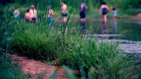 People wading or walking through a river Stock Footage 93676135